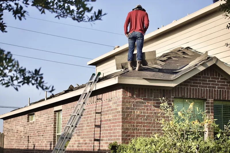 Professional roofer working on a residential roof in Kearney